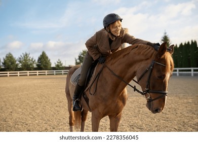 Female horse trainer with her stallion outdoors in farm - Powered by Shutterstock