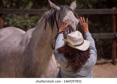 Female Horsehandler Setting Boundaries To A Horse.