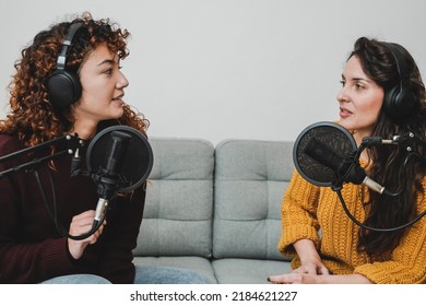 Female Host Recording Radio Podcast Interview With Guest At Home Office - Focus On Latin Woman Face