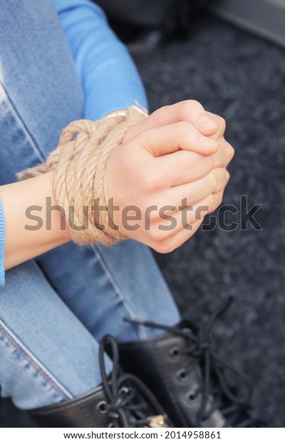 Female hostage with tied\
hands, closeup