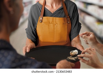 Female Hostess Holding Tasting Tray Inside Supermarket