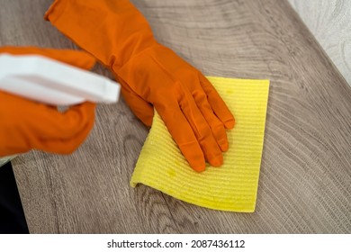 Female Housekeeping Hands In Gloves Cleaning Counter Top In Kitchen, Close Up. Cleaning Concept