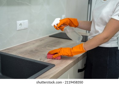 Female Housekeeping Hands In Gloves Cleaning Counter Top In Kitchen, Close Up. Cleaning Concept