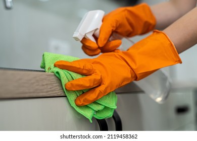 Female Housekeeping Hands In Gloves Cleaning Counter Top In Kitchen, Close Up. Cleaning Concept