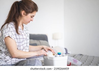 Female housewife checking medicines at domestic first aid kit neatly placing storage organization. Woman keeping vitamin, painkiller, bandage, antibiotics, blister. Container with pharmacy cure - Shutterstock ID 2190264459