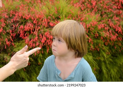 Female Index Finger. A Little Boy Listens To His Mother's Instructions Angry Mother Is Scolding At Her Son. Family Conflict Concept