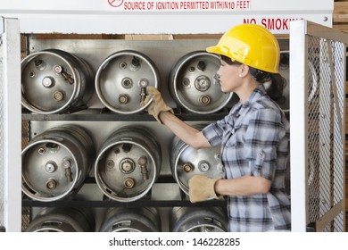 Female Industrial Worker Taking Out Propane Cylinder