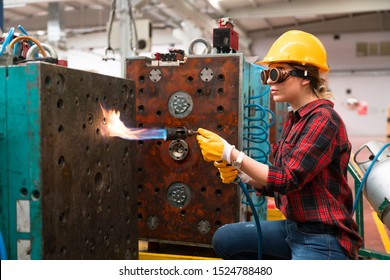 Female industrial worker working with blow torch in factory - Powered by Shutterstock