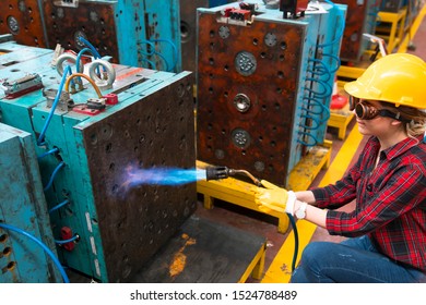 Female industrial worker working with blow torch in factory - Powered by Shutterstock