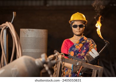 Female industrial worker working with blow torch in factory - Powered by Shutterstock