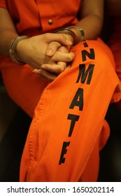 Female Inmate In Orange Jumpsuit