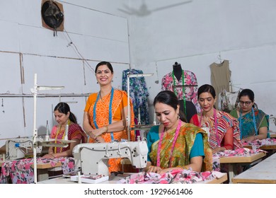 Female inspector with arms crossed at textile factory - Powered by Shutterstock