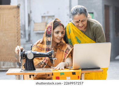 Female inspector guiding textile worker by using laptop. - Powered by Shutterstock