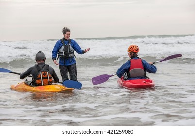 Female Instructor Talking To People In Sea Kayaks