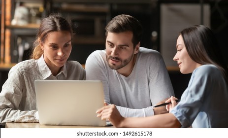 Female insurance mortgage broker agent consult young couple showing online presentation on laptop in office cafe, insurer financial advisor make business offer to interested clients look at computer