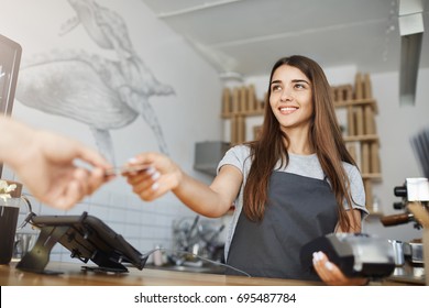 Female interacting with customer using a bank terminal to process and acquire credit card payments.
