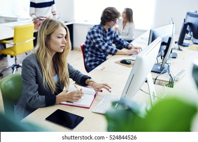 Female International Student Translating Business Article For Upcoming Exam Using Online Programs And Computer And Fast 4G Wifi Connection During Training Lesson In Modern University Workshop