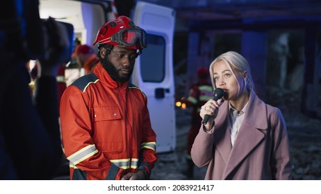 Female Interviewer Speaking With Black Paramedic