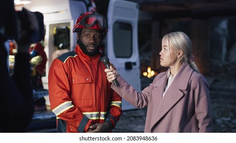 Female Interviewer Speaking With Black Paramedic