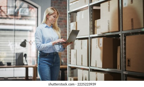 Female Inventory Manager Checks Stock, Writing in Clipboard App on Laptop Computer. Blond Woman Working in a Warehouse Storeroom with Rows of Shelves Full of Parcels, Packages Ready for Shipment. - Powered by Shutterstock