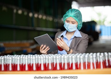 Female Inventory Manager with labtop is checking juice bottles before shipment. Inspection quality control. Manager  inspecting production line at drinks production factory
 - Powered by Shutterstock