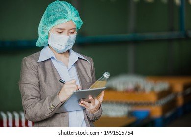 Female Inventory Manager with labtop is checking juice bottles before shipment. Inspection quality control. Manager  inspecting production line at drinks production factory
 - Powered by Shutterstock