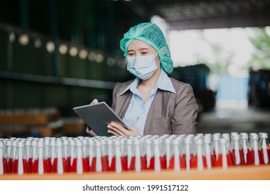 Female Inventory Manager with labtop is checking juice bottles before shipment. Inspection quality control. Manager  inspecting production line at drinks production factory
 - Powered by Shutterstock