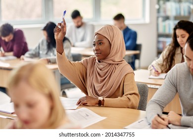 Female Islamic Student Raising Her Arm To Ask A Question During Lecture In The Classroom.