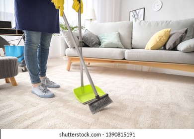 Female Janitor Cleaning Floor In Room