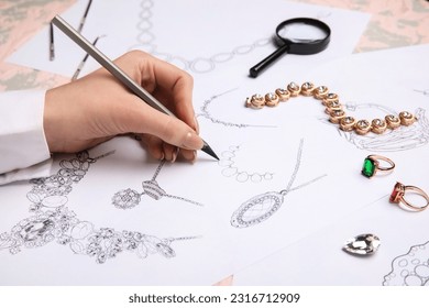 Female jeweler drawing adornment on grunge table, closeup - Powered by Shutterstock