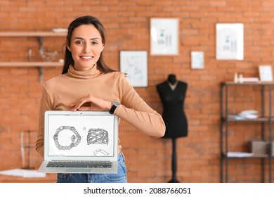 Female jewelry designer with laptop working in office - Powered by Shutterstock