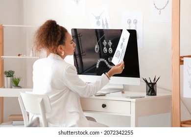 Female jewelry designer working in office - Powered by Shutterstock