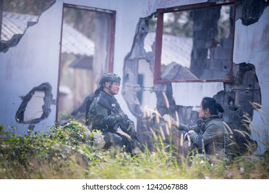 Female Journalist Interview Soldier During War Conflict. Photojournalist  Work On Gress Field Concept.