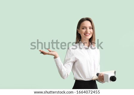 Female journalist on color background