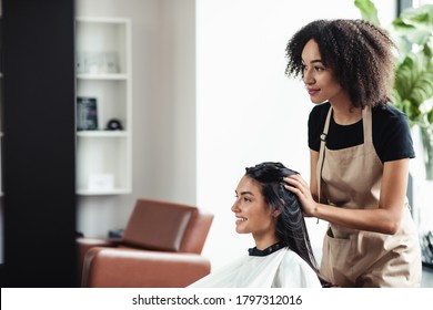 Female joy. Young brunette enjoying beauty procedures at hairdresser salon, empty space