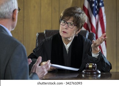 Female judge with male attorney in courtroom - Powered by Shutterstock