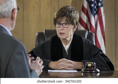 Female Judge With Male Attorney In Courtroom