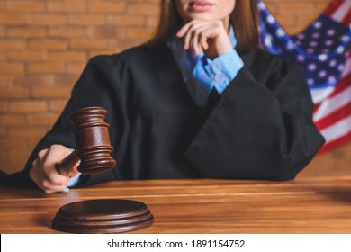 Female Judge At Table In Courtroom