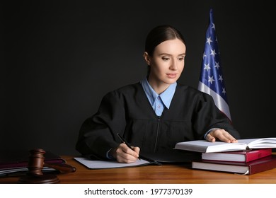 Female Judge At Table In Courtroom