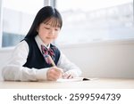 A female junior high school student wearing a uniform to take classes. She is taking notes in her notebook.