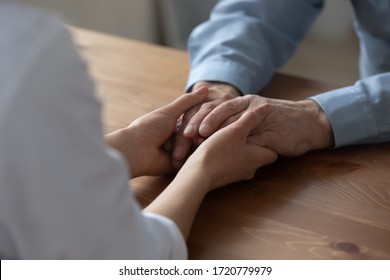 Female Kind Nurse Or Carer Holding Hands Of Elderly Adult Male Patient Giving Medical Care In Hospice Hospital Or At Home. Elder People Healthcare, Comfort And Compassion, Old People Support Concept.