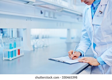 Female Lab Worker Making Notes