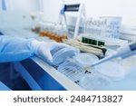 female laboratory assistant conducts research, chemical analysis, analysis of bacteria in the laboratory, doctor makes a test