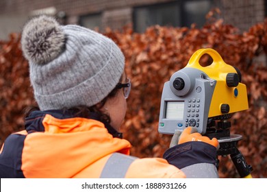 Female Land Surveyor Operating A Digital Precision Measurement Level To Establish Or Verify Or Measure The Height Of Specified Points Relative To A Datum. Copenhagen, Denmark - January 7  2020.