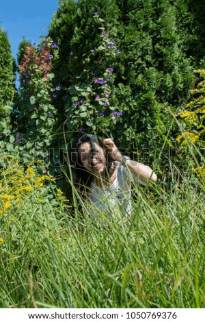 Similar – eine frau vor  einer blumenwiese. blumen pflücken