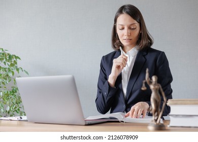 a female lawyer conducts an online consultation from a laptop via video link for a client. work in a law firm checking documents or contracts via the Internet. european young adult female attorney or - Shutterstock ID 2126078909