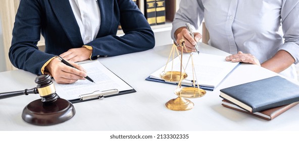 Female Lawyer Or Counselor Working In Courtroom Have Meeting With Client Are Consultation With Contract Papers Of Real Estate, Law And Legal Services Concept.