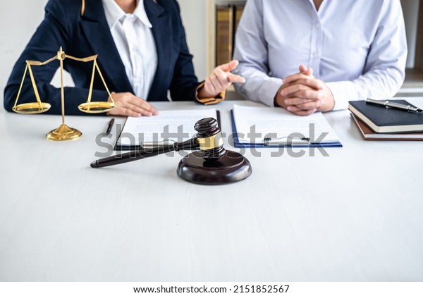Female lawyer or Counselor working in\
courtroom have meeting with client are consultation with contract\
papers of real estate, Law and Legal services\
concept.