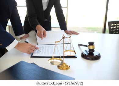 Female lawyer Legal counsel presents to the client a signed contract with gavel and legal law. justice and lawyer woman business  concept