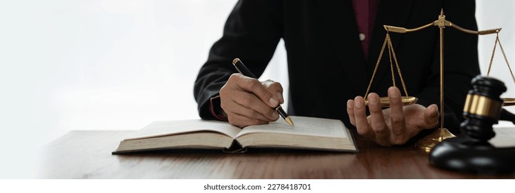 Female lawyer, legal counsel reading legal information book business deal with the other hand measuring the weight with the scales in order to determine the results of analyzing the correct principles - Powered by Shutterstock